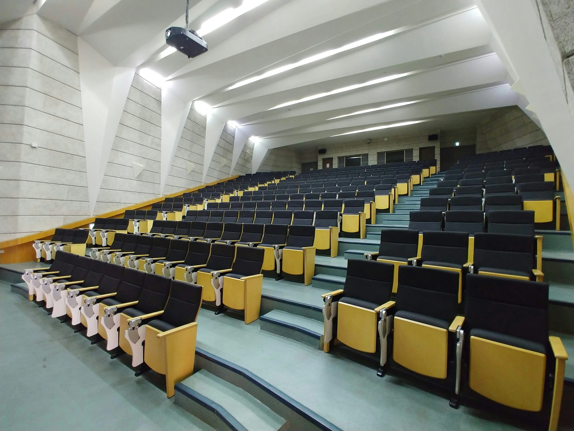 rows of auditorium seats and steps in a room