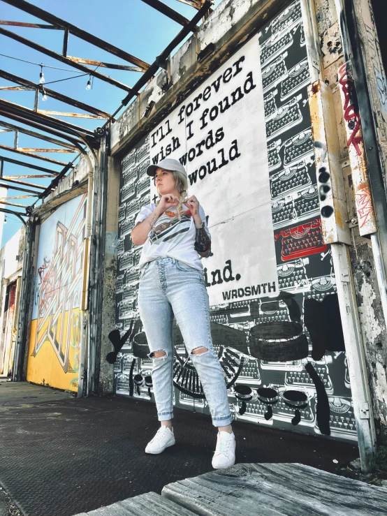 a man stands in front of a mural