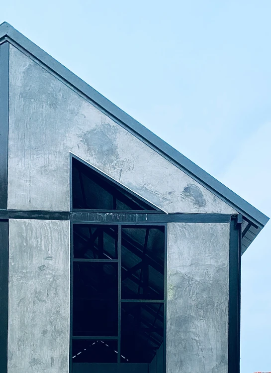 the top of a white building with black windows