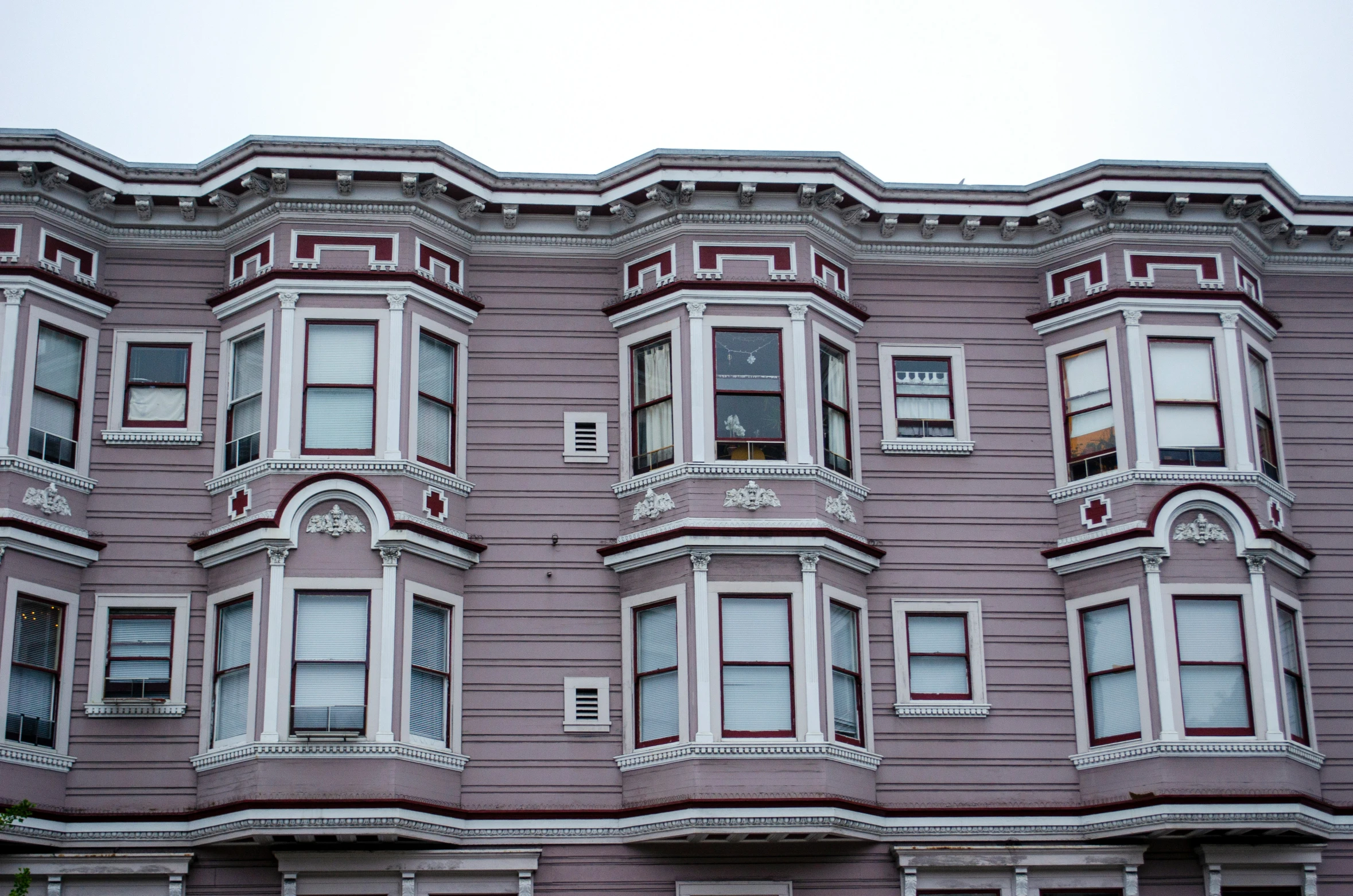 an old building with three story windows and white shutters