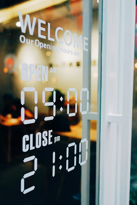 a clock that is sitting on the side of a glass door