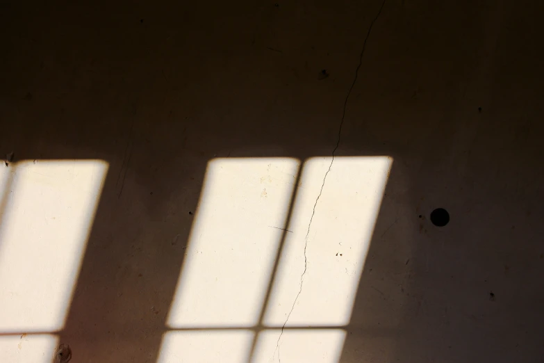 the shadows of three windows of a room