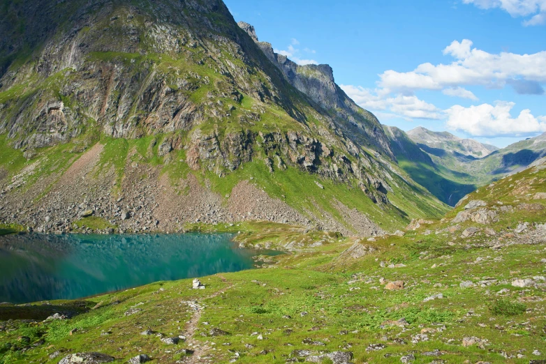 two mountain side rivers with one blue body of water