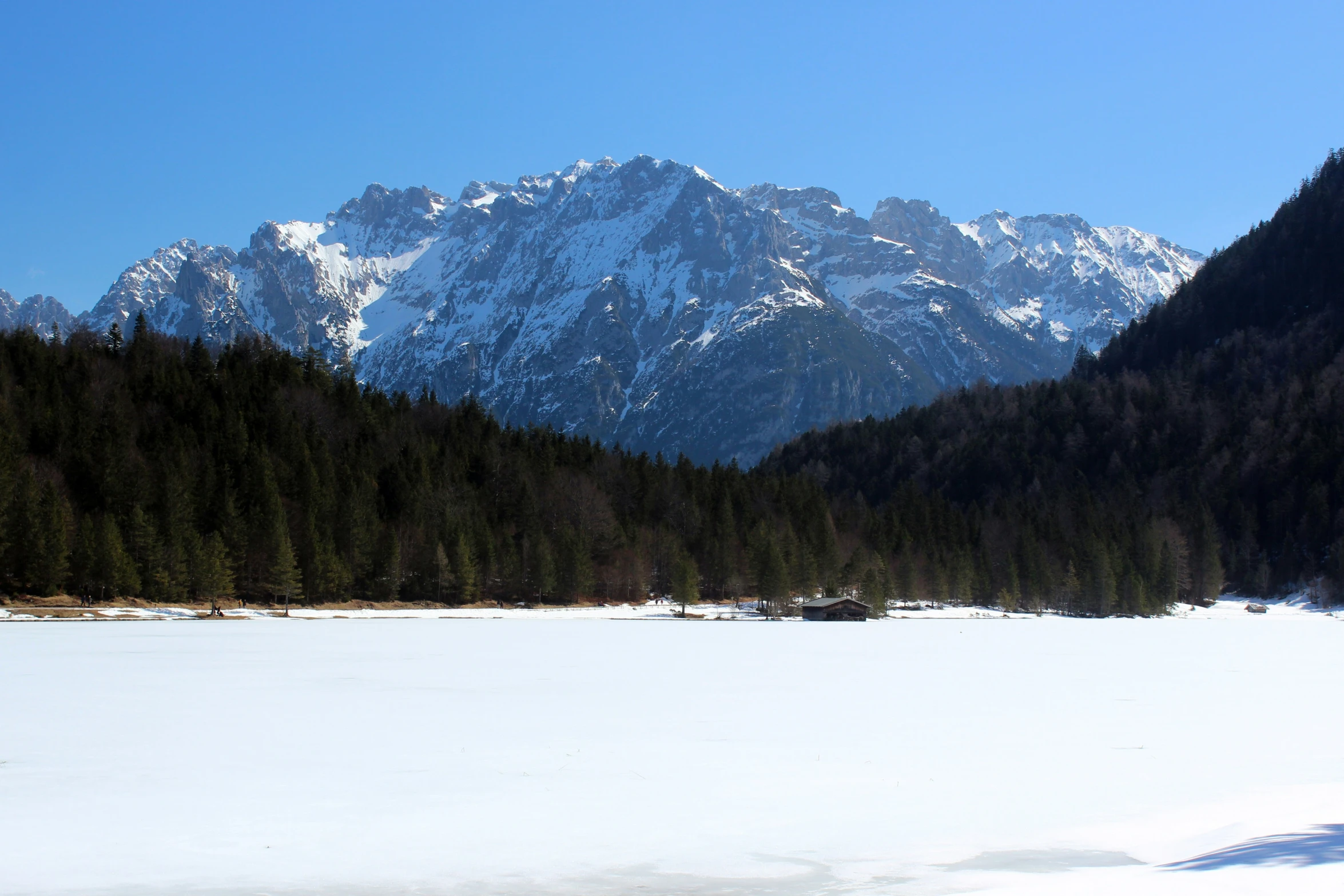 the mountain range has some snow on it