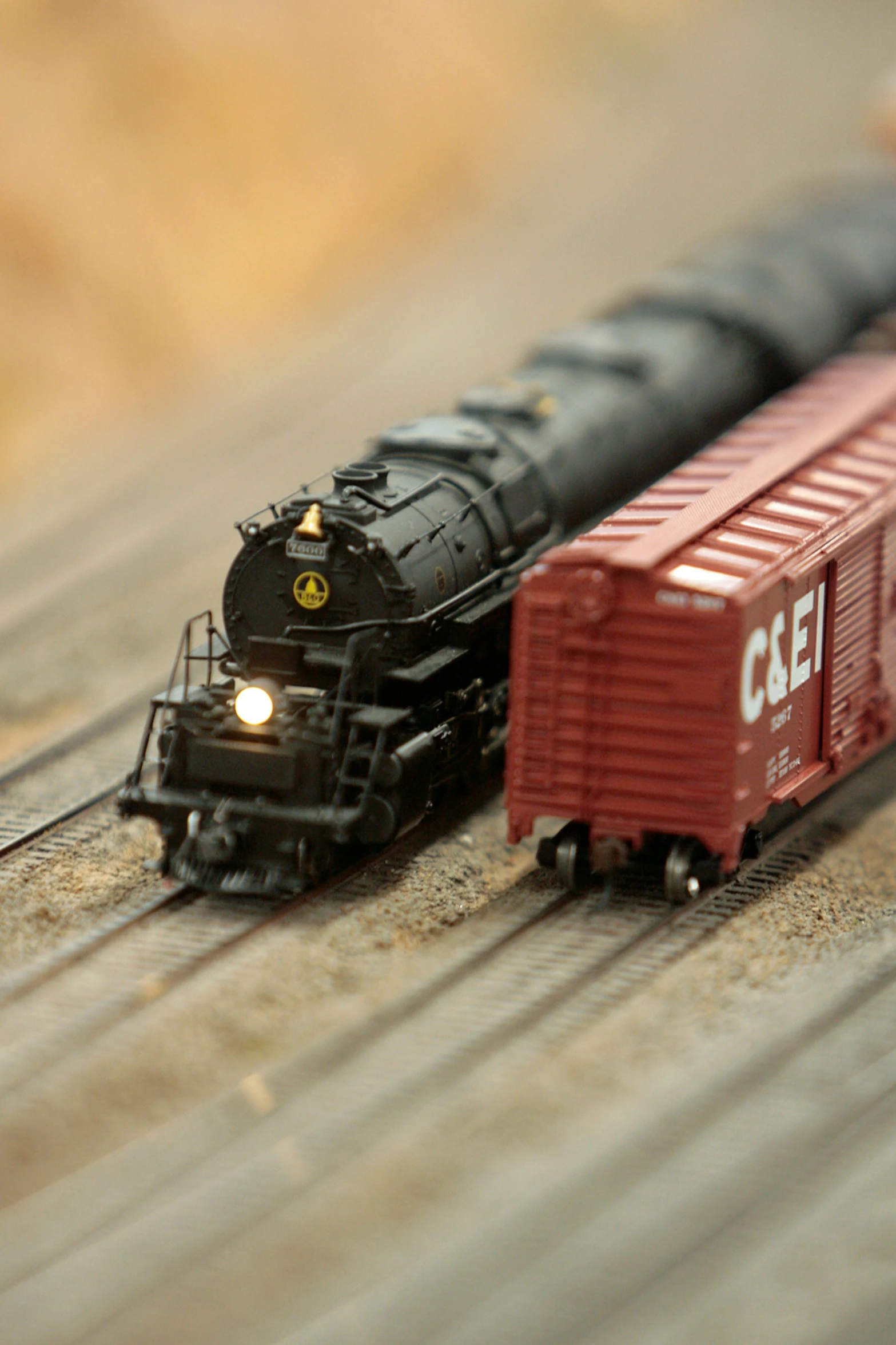 two toy trains passing each other on a track