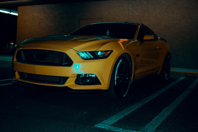 an automobile is sitting in a car park in the dark