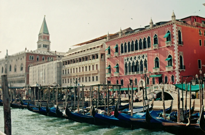 several gondola lined up next to some buildings in venice