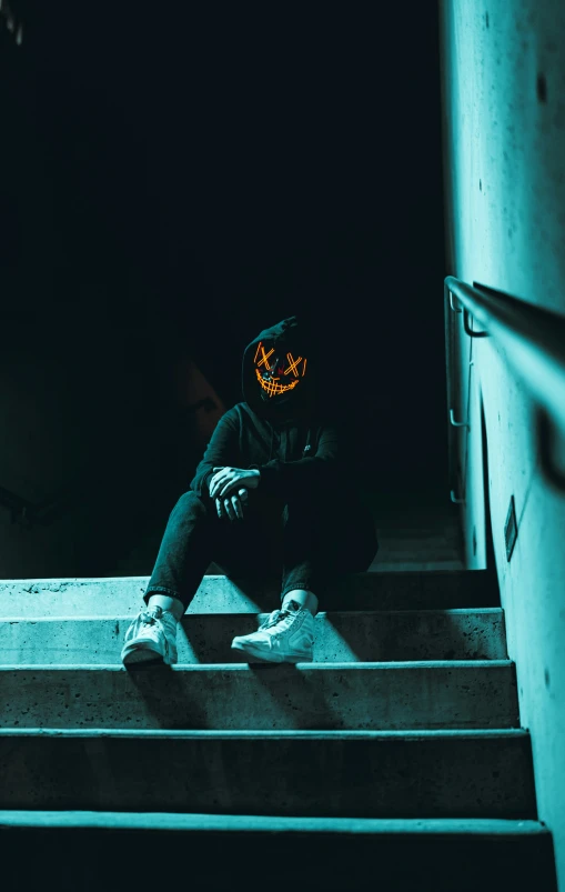 a person with a scary mask is sitting on steps