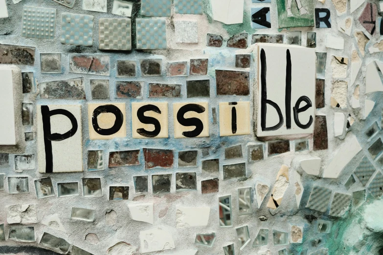 the word possible on a mosaic stone wall