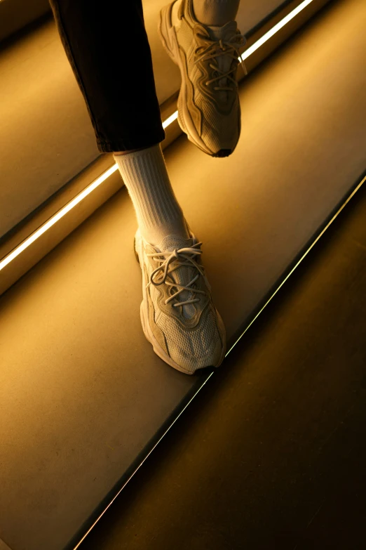 a person with shoes walking down a hallway