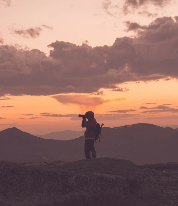 a person looking up into the sky at dusk