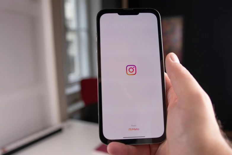 an apple iphone is showing the instagram logo on its display