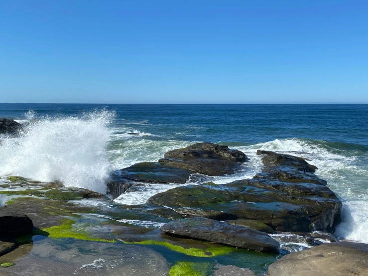 some rocks and water near a body of water