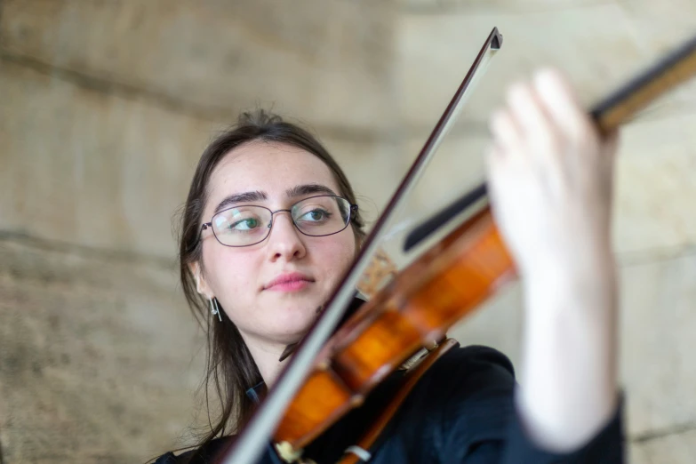 the  has glasses on playing the violin