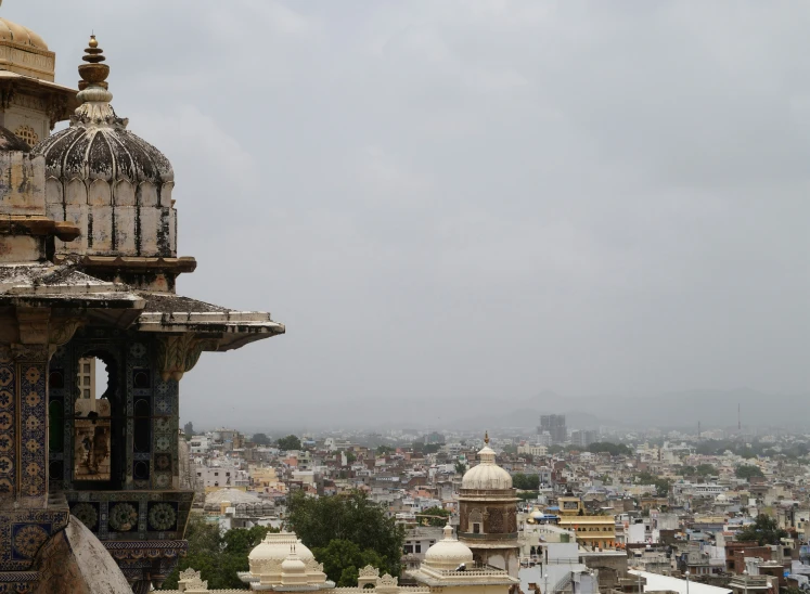 the view from top of a building with large rooftops and a dome