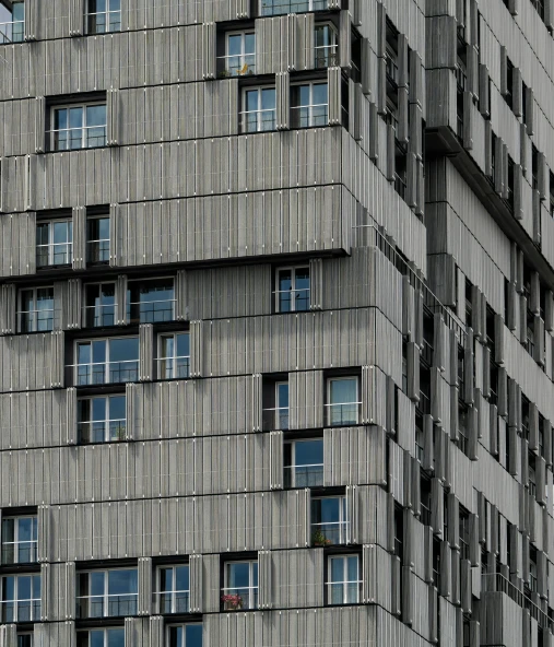 a tall building with many windows and white curtains