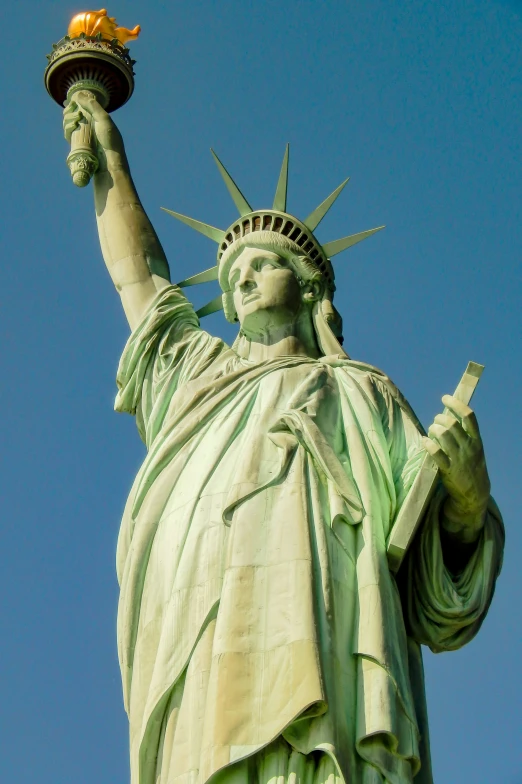 the statue of liberty is against a clear sky