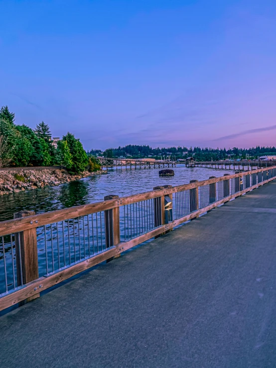 a man on a bicycle rides across a bridge