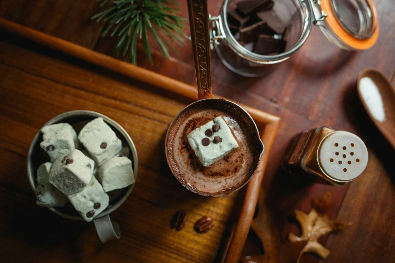 small brown sugars sit in small bowls on top of a wooden table