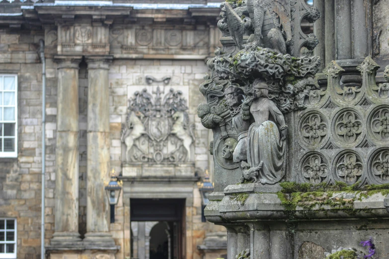 a statue sitting on the side of a stone building