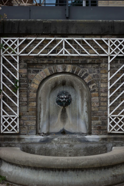 a close up view of the corner of a stone structure with a fountain