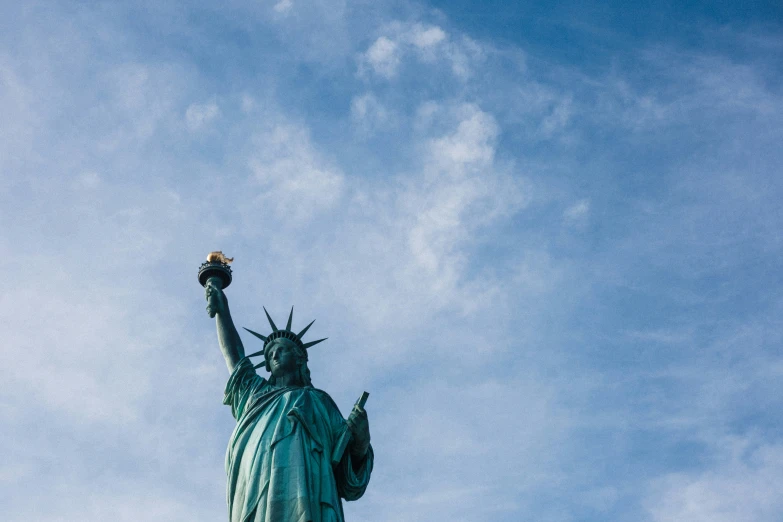 a close up of a statue of liberty under the sky