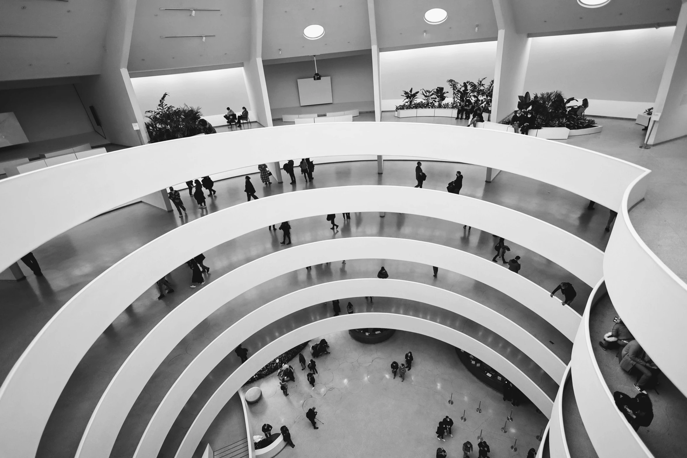 people are walking around inside a white building