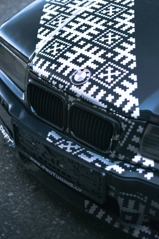 the front end of an odd bmw car with pattern