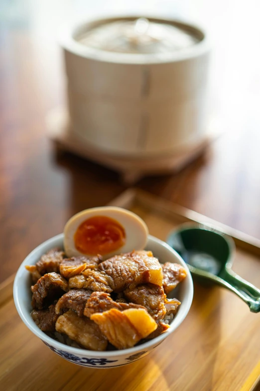 a small bowl of food sitting on a table with a spoon