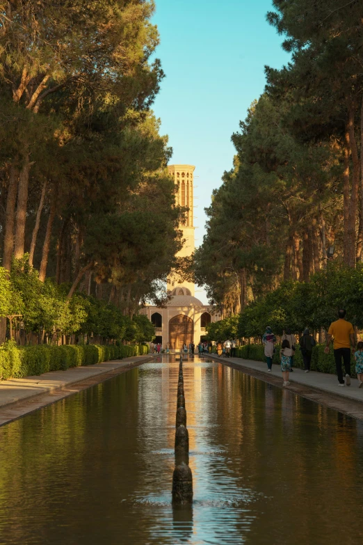 the reflection of people and trees on the water