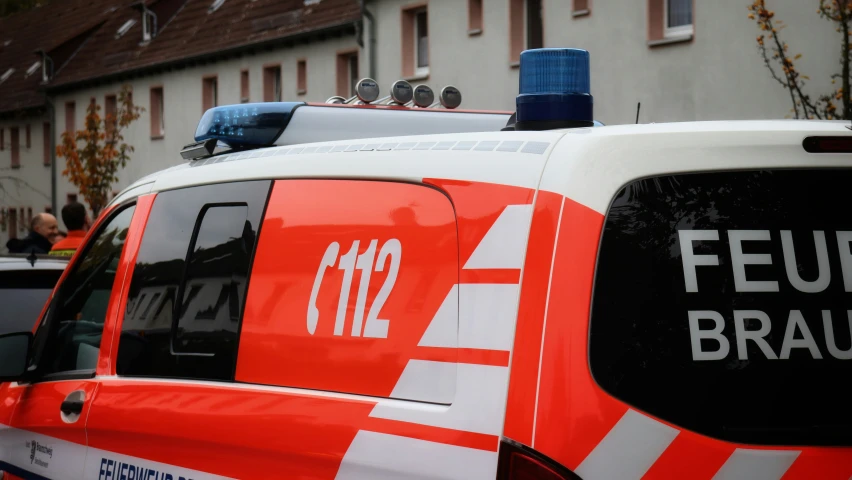 an emergency vehicle is parked in front of some buildings