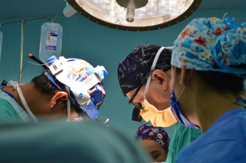 a group of surgeons work together to prepare for 