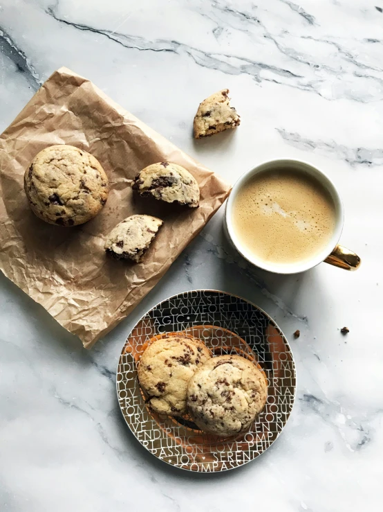 a marble counter top with cookies and coffee