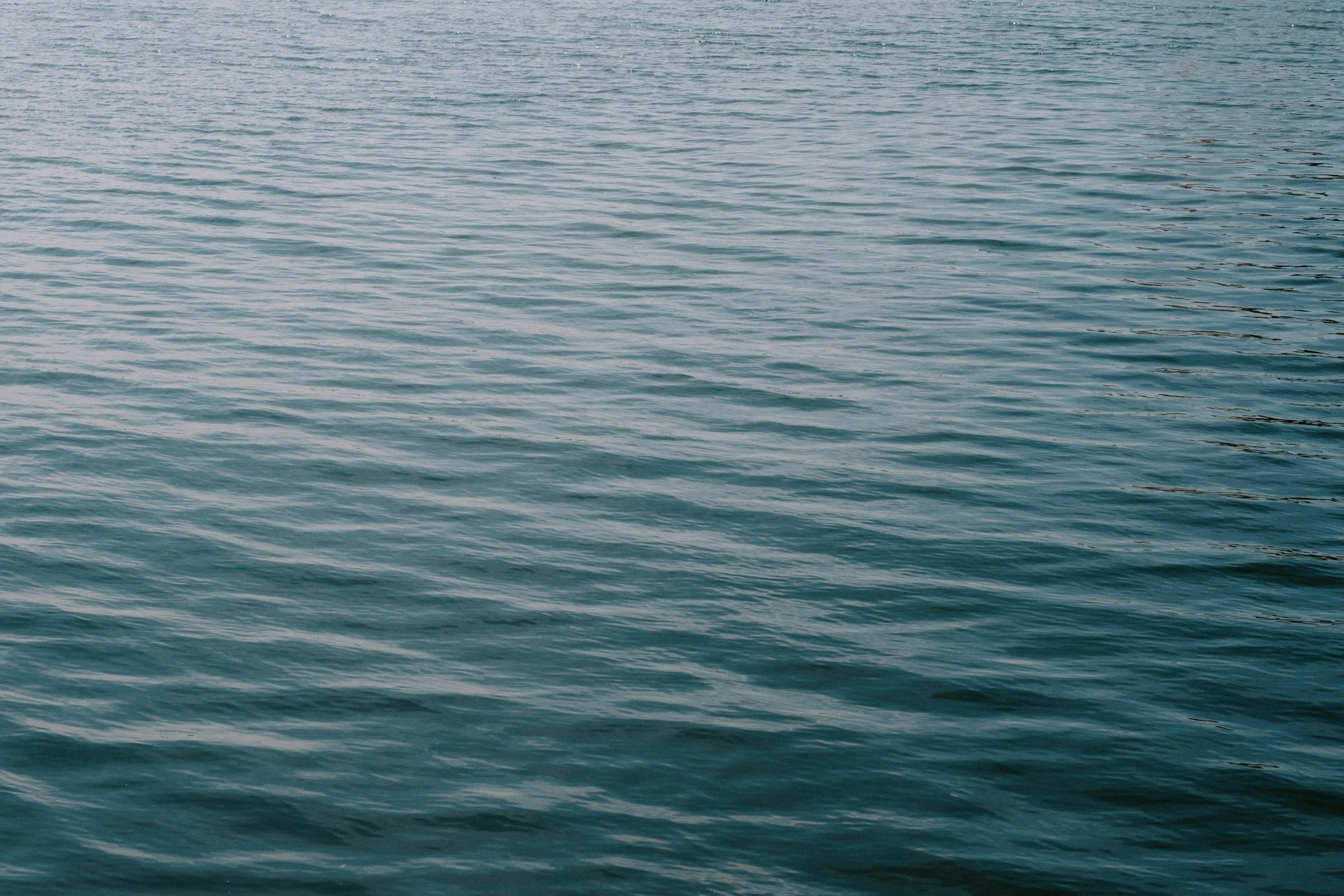 a boat sitting on top of the ocean