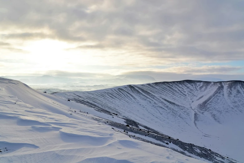 snowy slope covered with white snow with mountains in the background