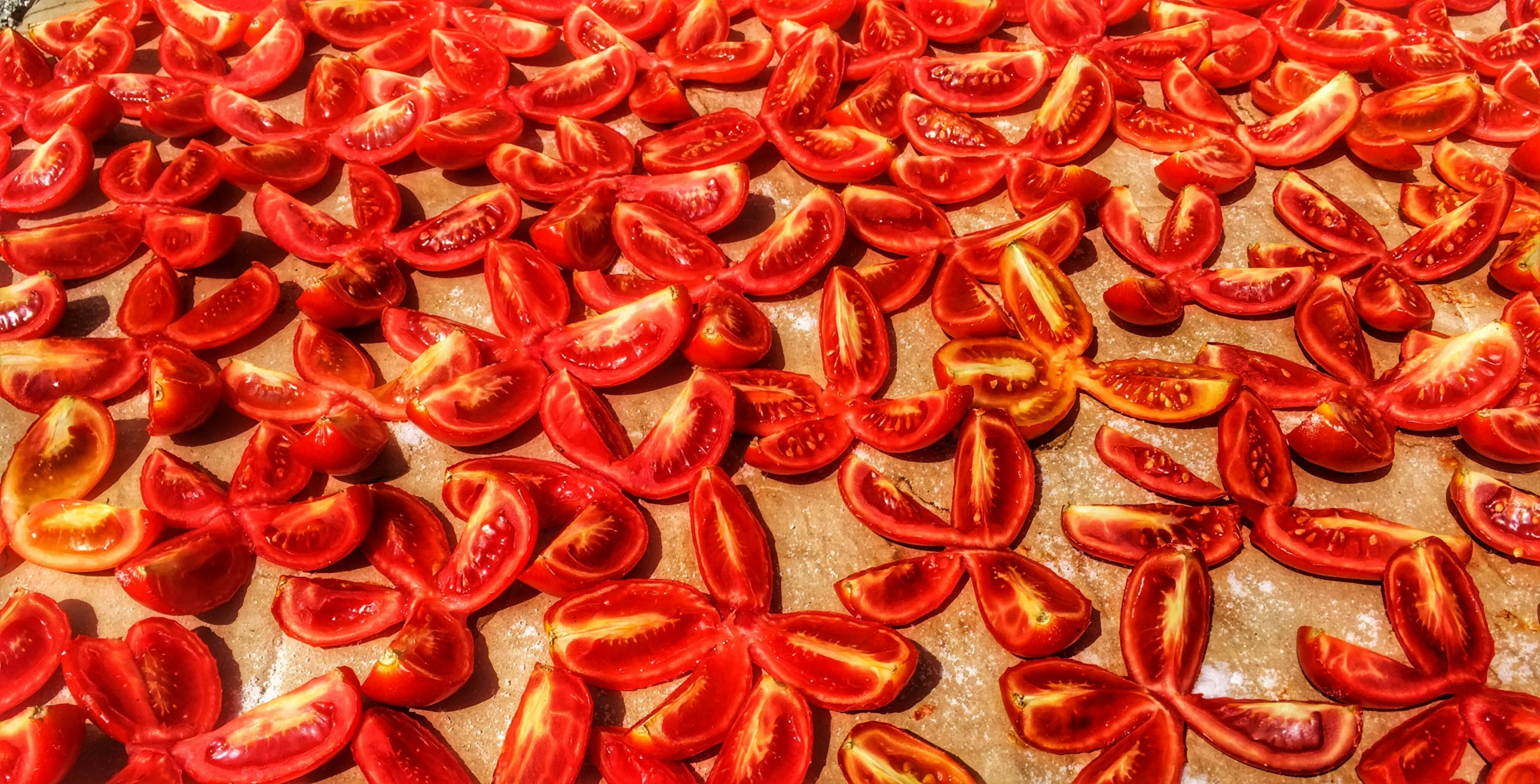 fresh tomatoes sitting on a  board to be chopped up