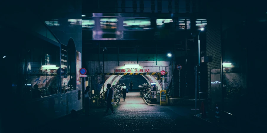 people walk out of the dark tunnel entrance