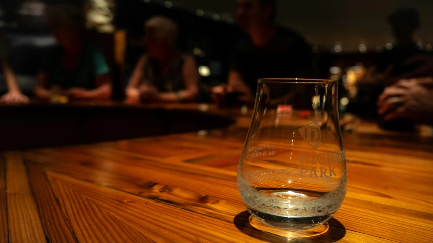 the bottom of a glass on top of a wooden table