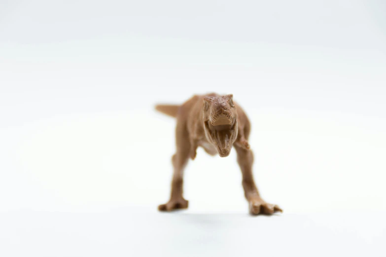 a toy dog on white background with a tiny blurry image of an animal