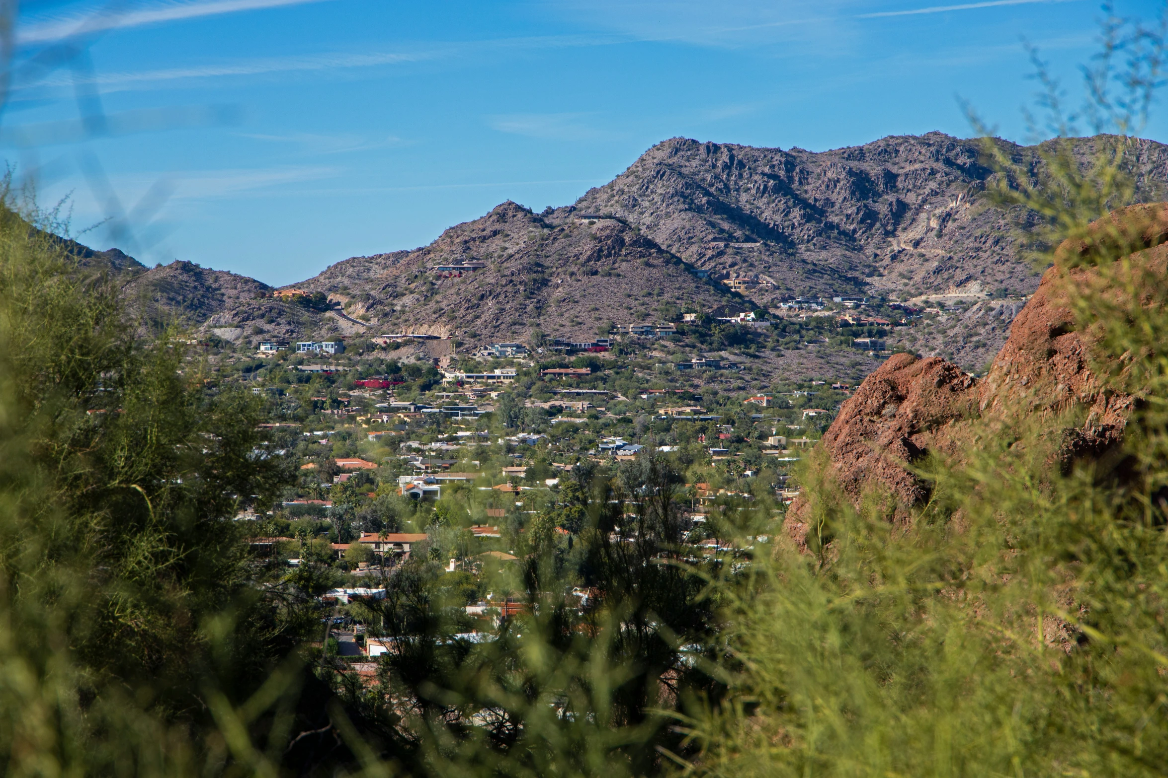 the view of a town nestled near mountains from a distance