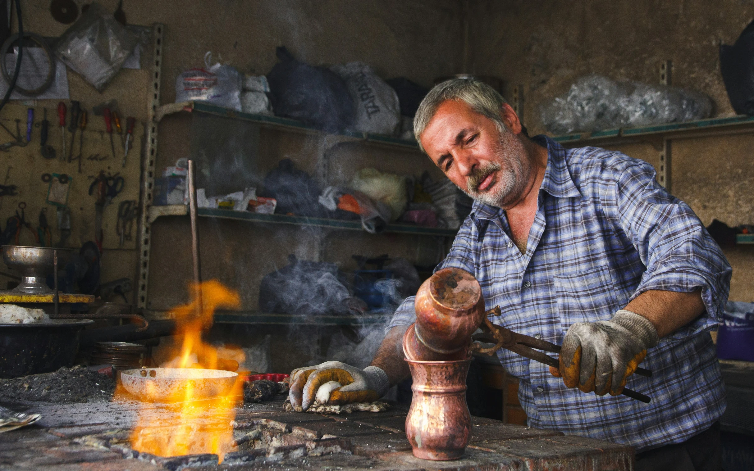 a man is using an object in his blacksmith