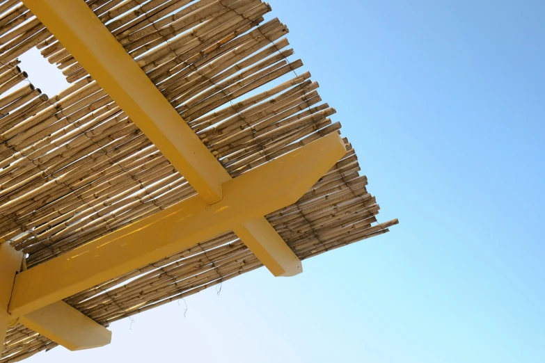 the underside of a wooden structure with a clear sky