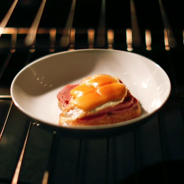 a plate of food with eggs and ham in the center