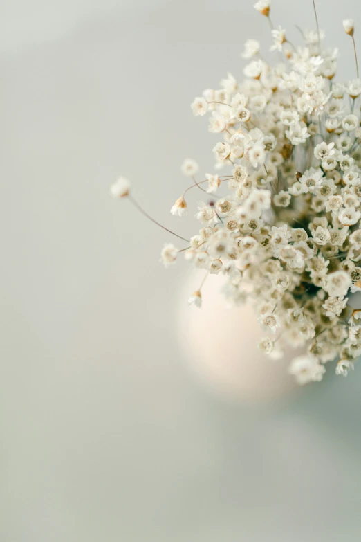 a vase full of flowers on a white table