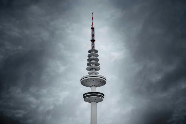 a tall spire sits against a cloudy sky