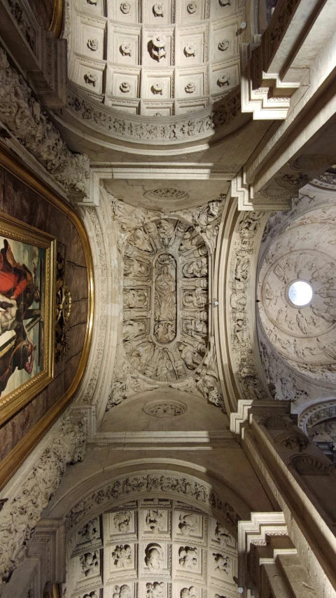 a ceiling view from the ground with some paintings on it