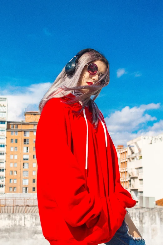 a woman with a red hoodie and a veil on her head