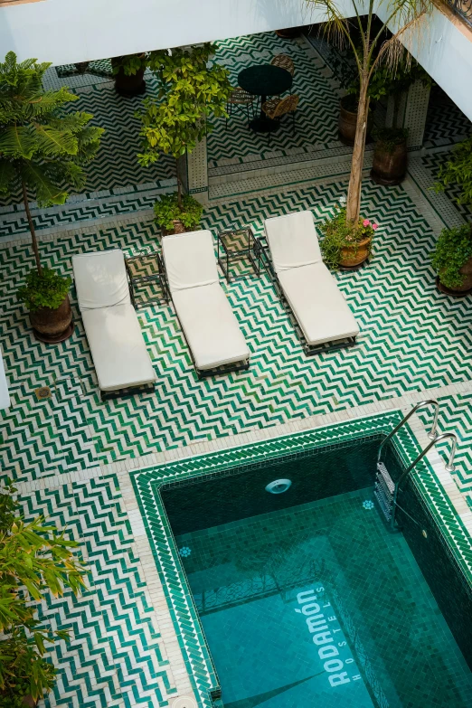 an outdoor pool with lounge chairs on it
