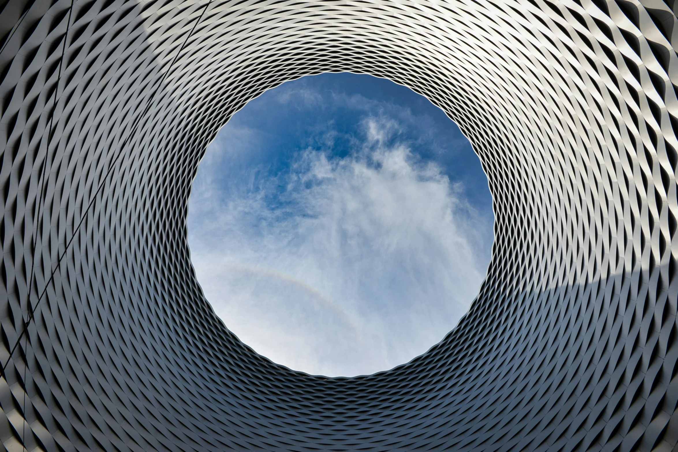 looking up at the sky through a very large circular hole