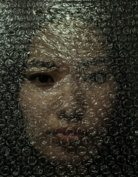 a reflection of a woman through a glass curtain